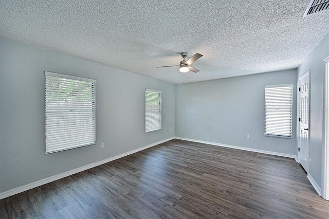 spare room featuring ceiling fan, a textured ceiling, and dark hardwood / wood-style floors