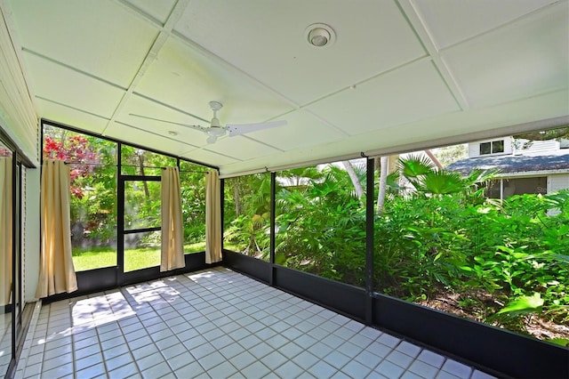 unfurnished sunroom with ceiling fan and plenty of natural light