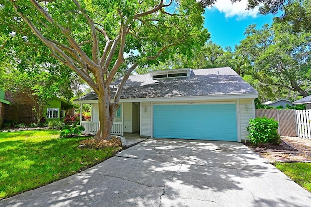 view of front of property with a garage and a front lawn