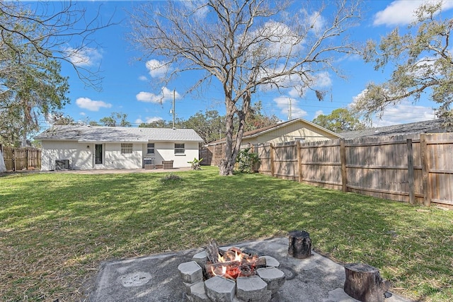 view of yard with a patio area and an outdoor fire pit