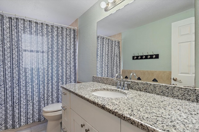 bathroom with tile patterned floors, vanity, and toilet