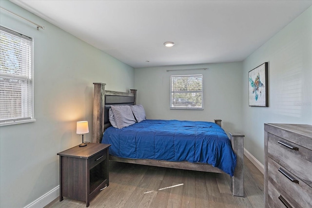 bedroom with dark hardwood / wood-style floors