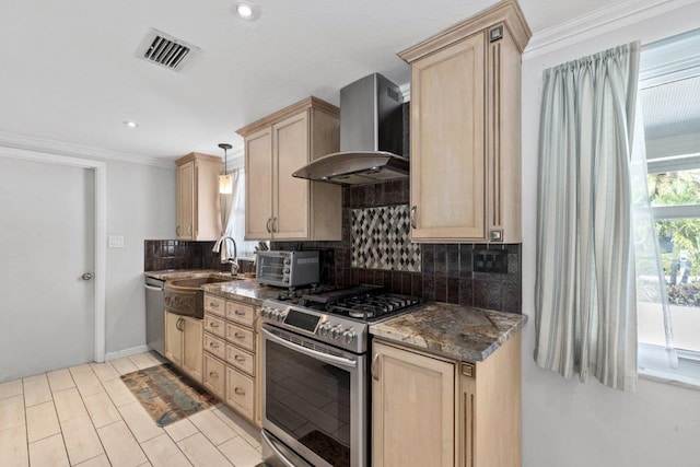 kitchen with light brown cabinetry, sink, wall chimney exhaust hood, and stainless steel appliances