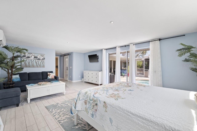 bedroom with access to outside, light hardwood / wood-style flooring, and an AC wall unit