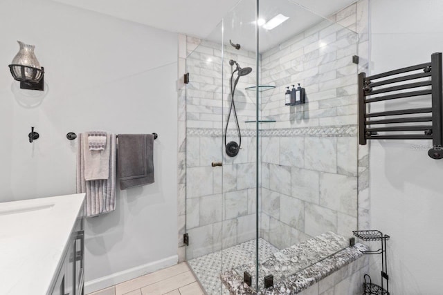 bathroom with radiator, vanity, and an enclosed shower