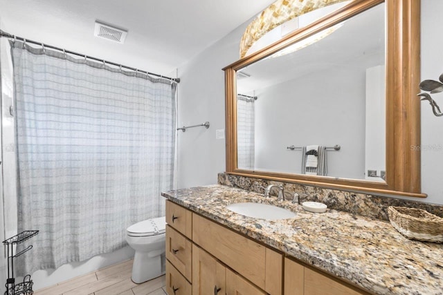 full bathroom with hardwood / wood-style floors, vanity, toilet, and shower / bath combo