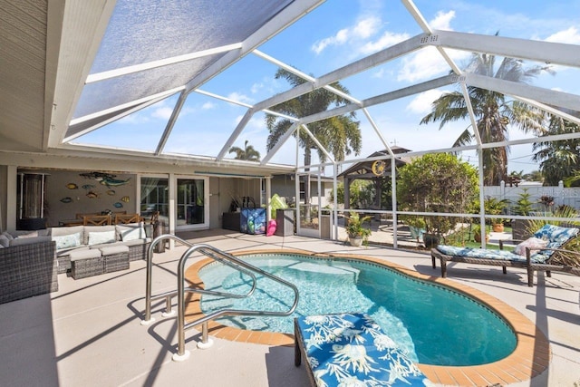 view of pool with glass enclosure, an outdoor living space, and a patio