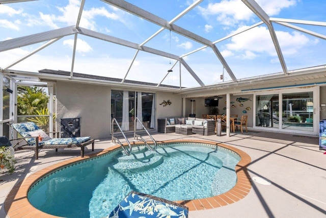 view of pool with outdoor lounge area, glass enclosure, ceiling fan, and a patio area