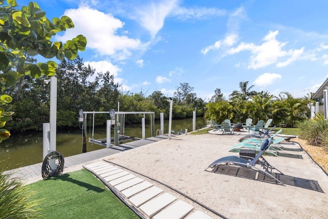 exterior space featuring a boat dock and a water view