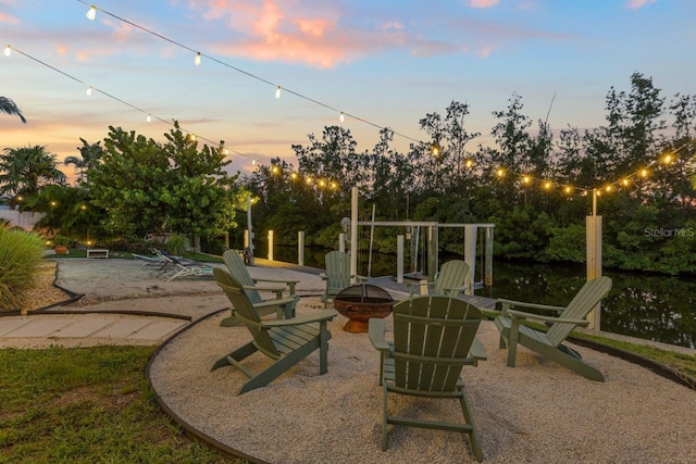 patio terrace at dusk featuring an outdoor fire pit