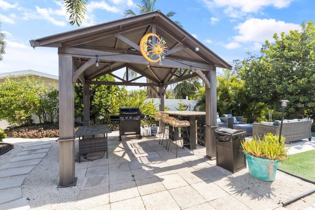 view of patio / terrace featuring a gazebo, a grill, exterior bar, and an outdoor hangout area