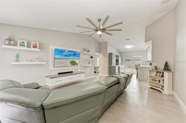 living room with ceiling fan, lofted ceiling, and light tile patterned floors