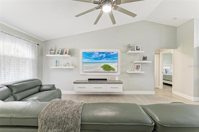 living room featuring light hardwood / wood-style floors, vaulted ceiling, and ceiling fan