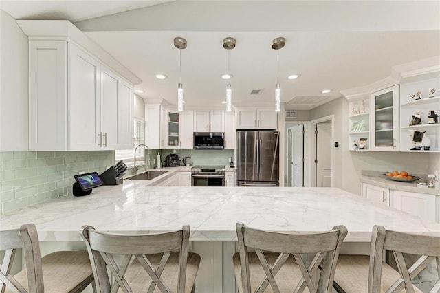 kitchen featuring stainless steel appliances, a breakfast bar area, and sink