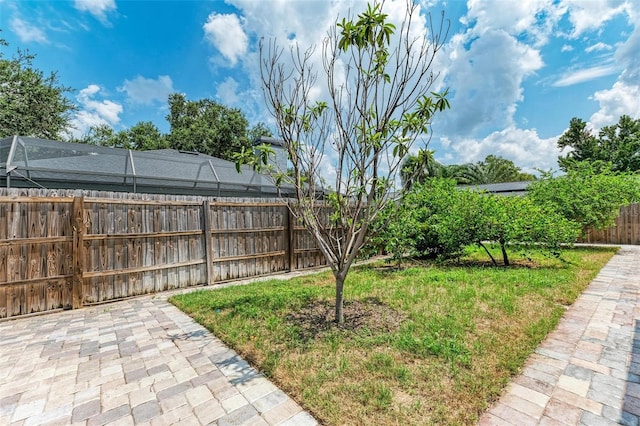 view of yard featuring glass enclosure