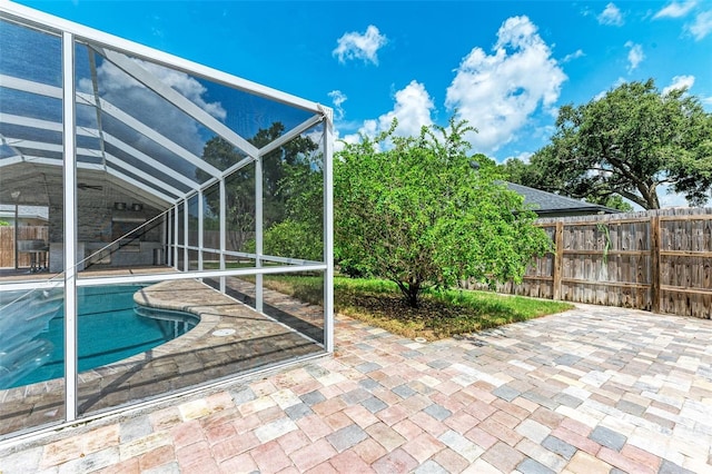 view of pool with a patio area and a lanai