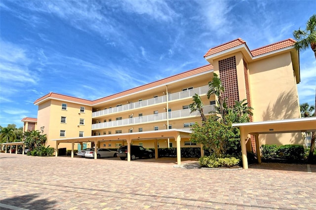 view of building exterior with covered parking