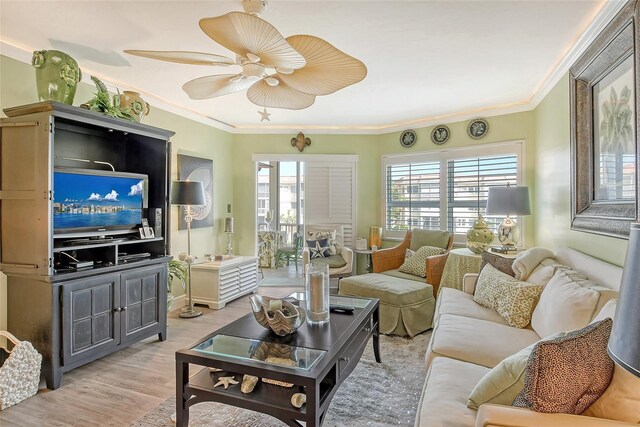 living room featuring crown molding, ceiling fan, and wood-type flooring