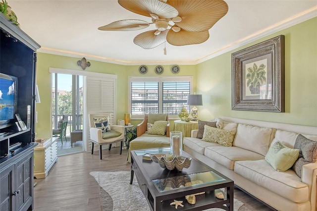 living room with crown molding, hardwood / wood-style flooring, and ceiling fan