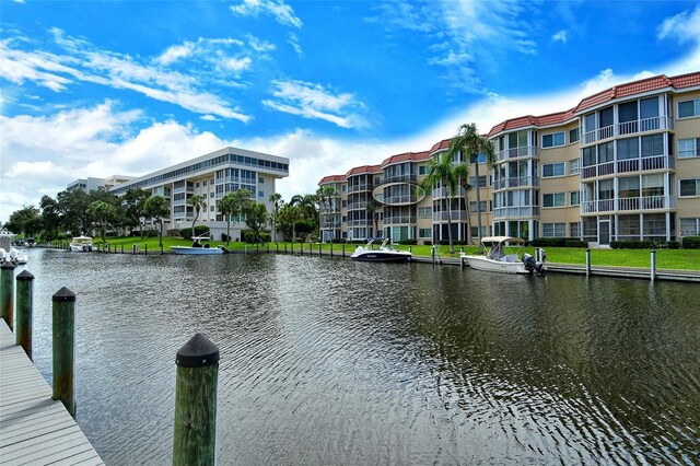 dock area with a water view and a balcony