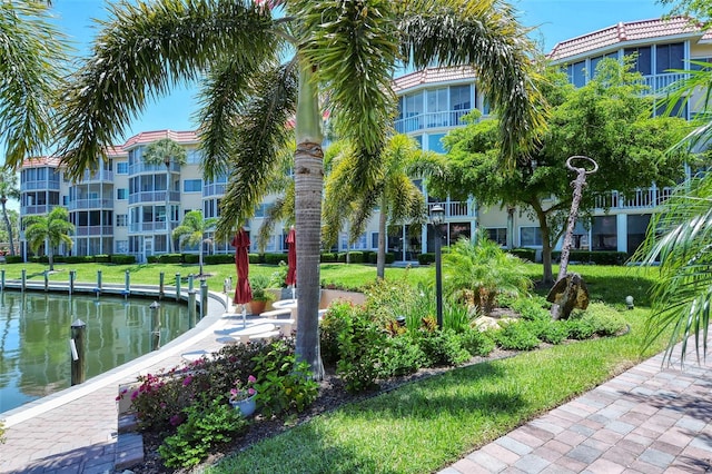 view of home's community featuring a water view and a yard