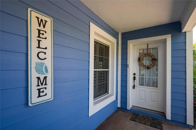 view of exterior entry with a porch