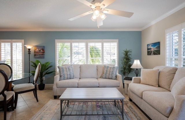 tiled living room featuring ornamental molding, baseboards, and a ceiling fan