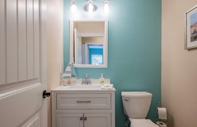 bathroom featuring vanity and toilet