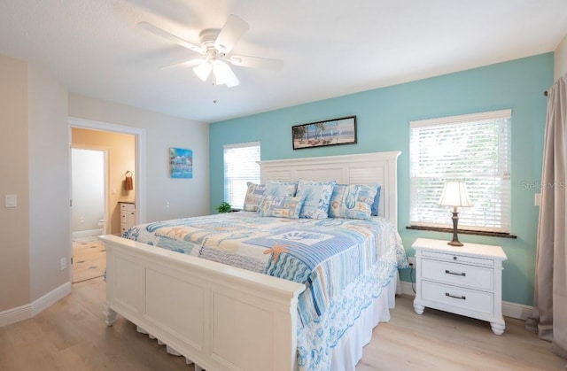 bedroom featuring ceiling fan, light wood-type flooring, and ensuite bathroom