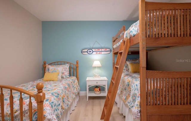 bedroom featuring baseboards and light wood finished floors