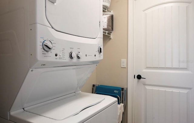 clothes washing area with laundry area and stacked washing maching and dryer