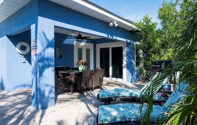 view of patio with a ceiling fan, outdoor dining area, and grilling area