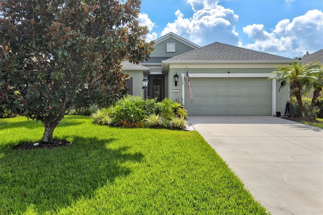 view of front of property with a front yard and a garage