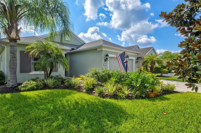 view of front of property with a garage and a front yard