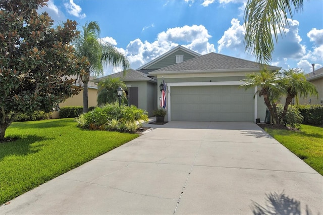 view of front of home with a front yard and a garage