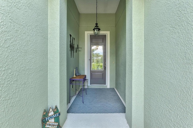 entrance to property with stucco siding