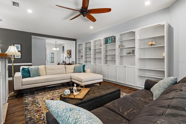 living room with ceiling fan and dark wood-type flooring