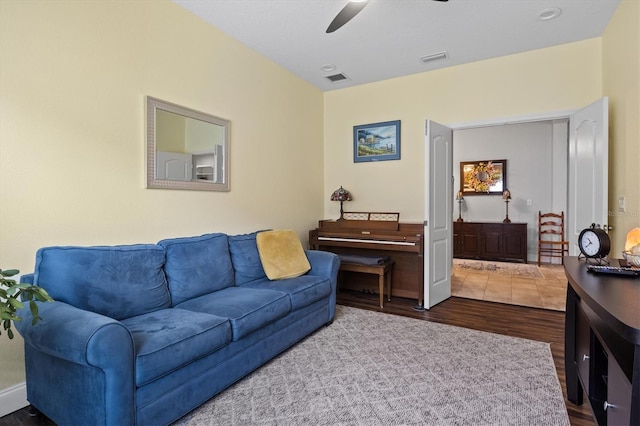 living area featuring visible vents, wood finished floors, and a ceiling fan