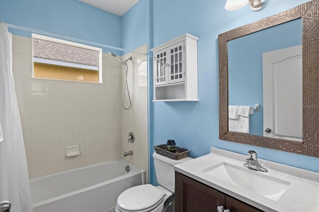 full bathroom featuring shower / bath combo, vanity, and toilet