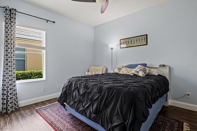 bedroom with ceiling fan and dark wood-type flooring