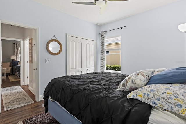 bedroom with dark wood-type flooring, a closet, ceiling fan, and baseboards