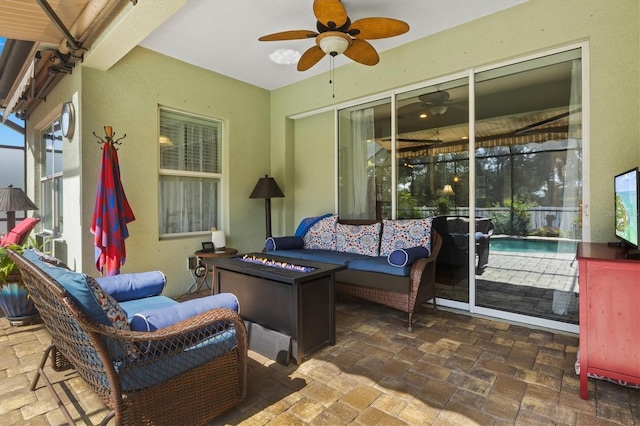 view of patio / terrace with ceiling fan and an outdoor living space