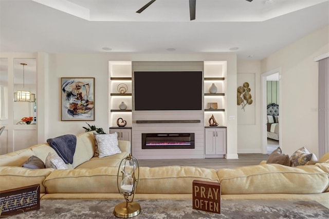 living room featuring hardwood / wood-style flooring and ceiling fan