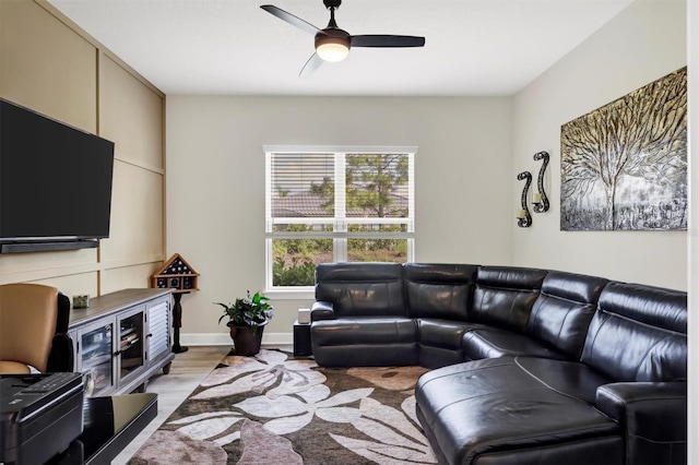 living room with light hardwood / wood-style floors and ceiling fan