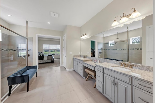 bathroom with tile patterned floors, vanity, and walk in shower