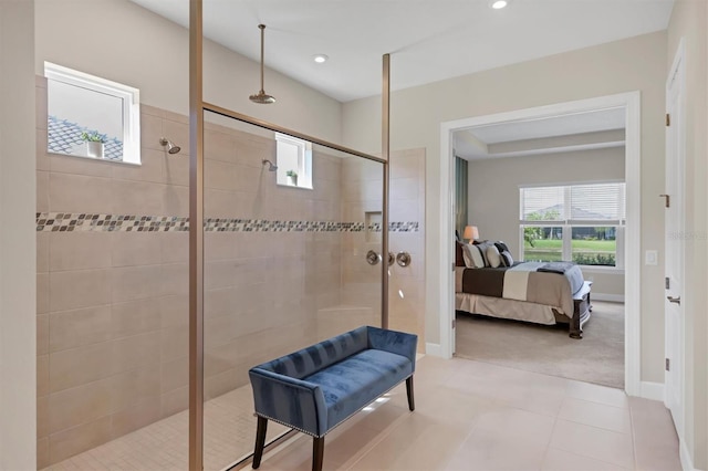 bathroom featuring tiled shower and tile patterned floors