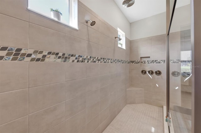 bathroom featuring plenty of natural light and a tile shower