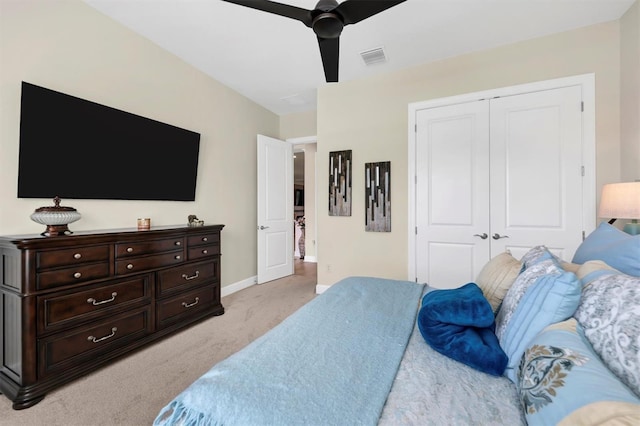 bedroom featuring a closet, ceiling fan, and light colored carpet