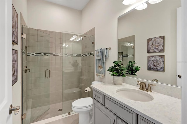 bathroom with vanity, tile patterned flooring, toilet, and a shower with shower door