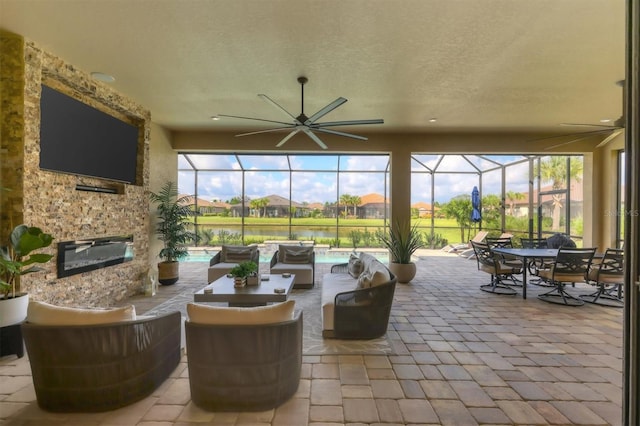 view of patio featuring glass enclosure and outdoor lounge area